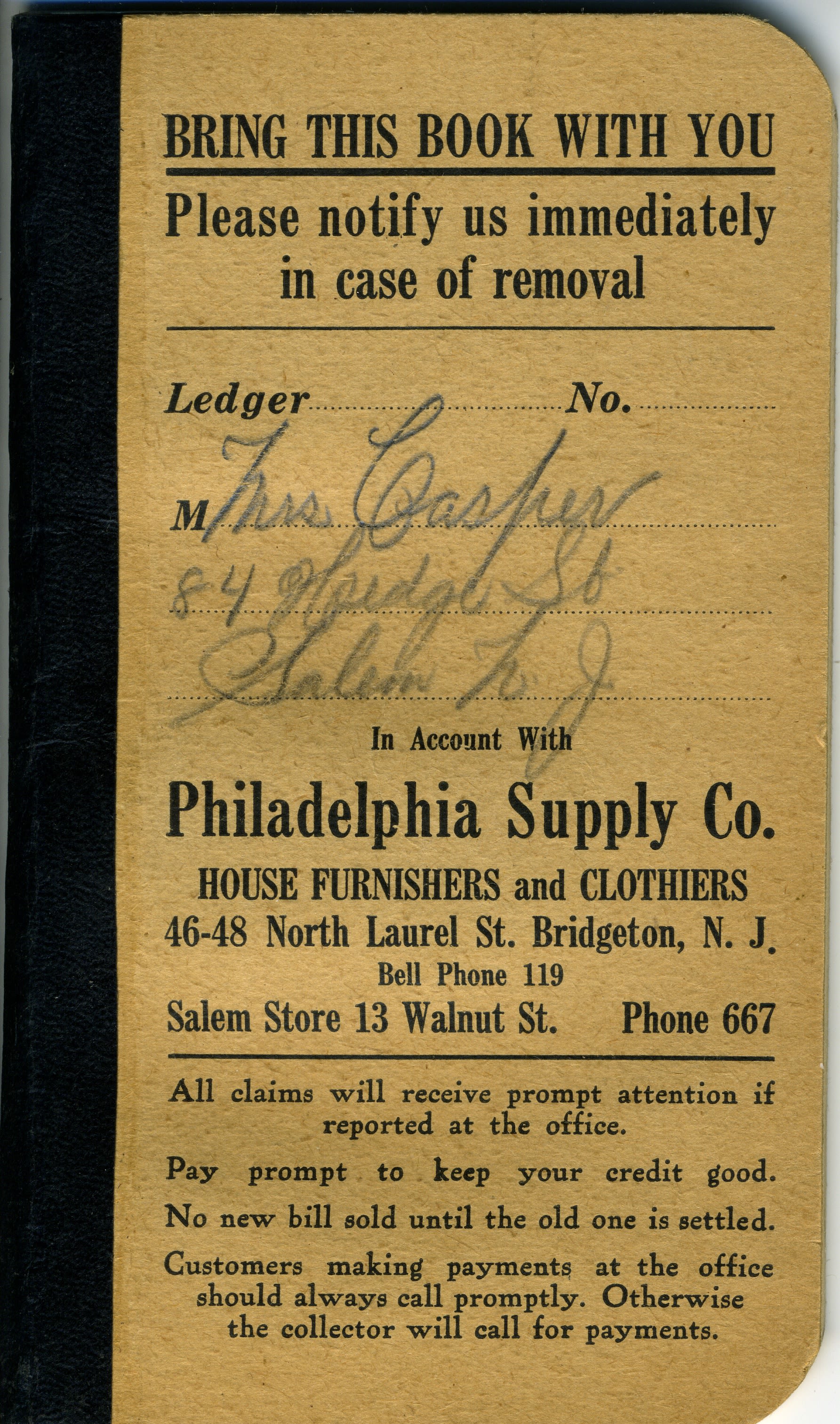Image of a small tan and black account book.